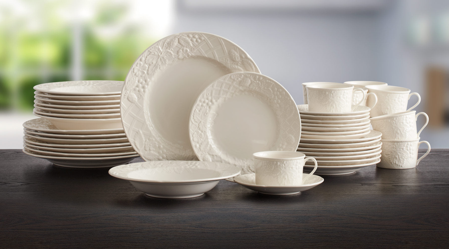 On an embossed garden trellis, leaves, flowers and fruit surround the clean centers of this dinnerware, bringing to mind an English Countryside.
