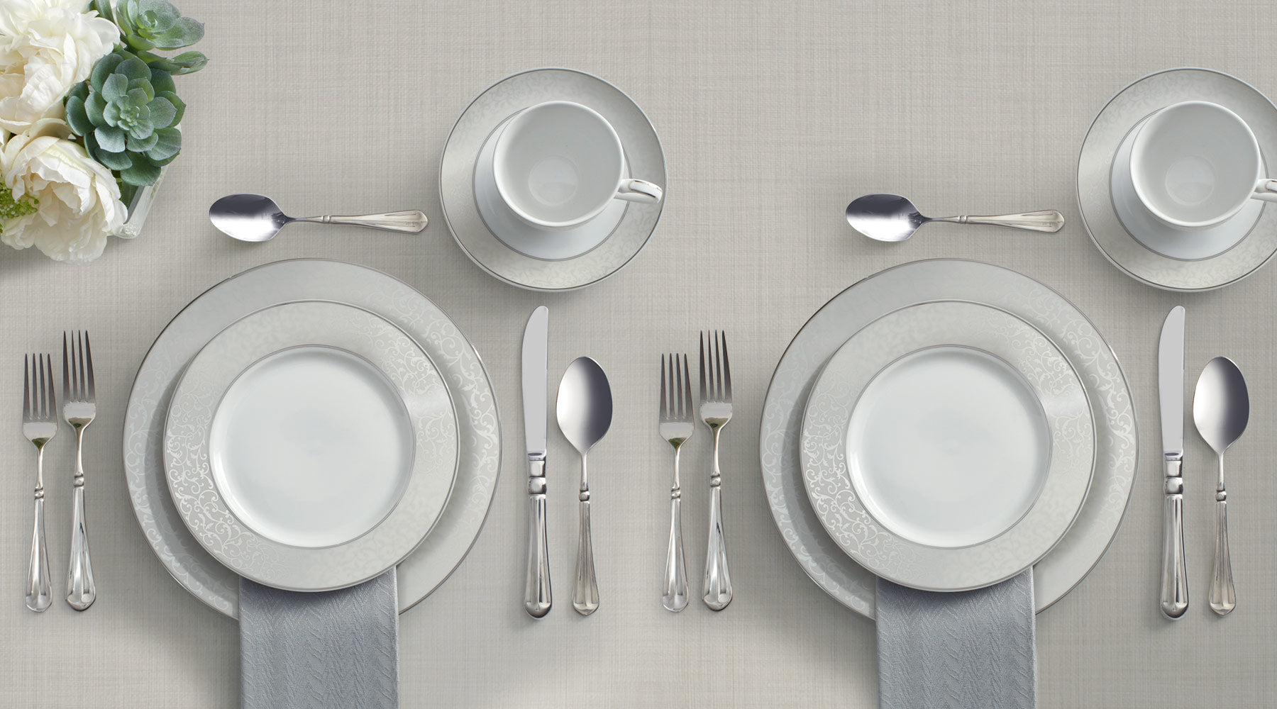 The Parchment dinnerware collection features a soft gray border embellished with a beautifully detailed scroll design in rich platinum..