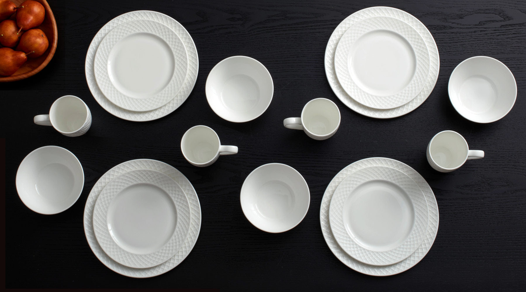 A simple, white collection with a contemporary, crisscrossing line design framing each piece, creating eye-catching depth and movement across your tabletop.
