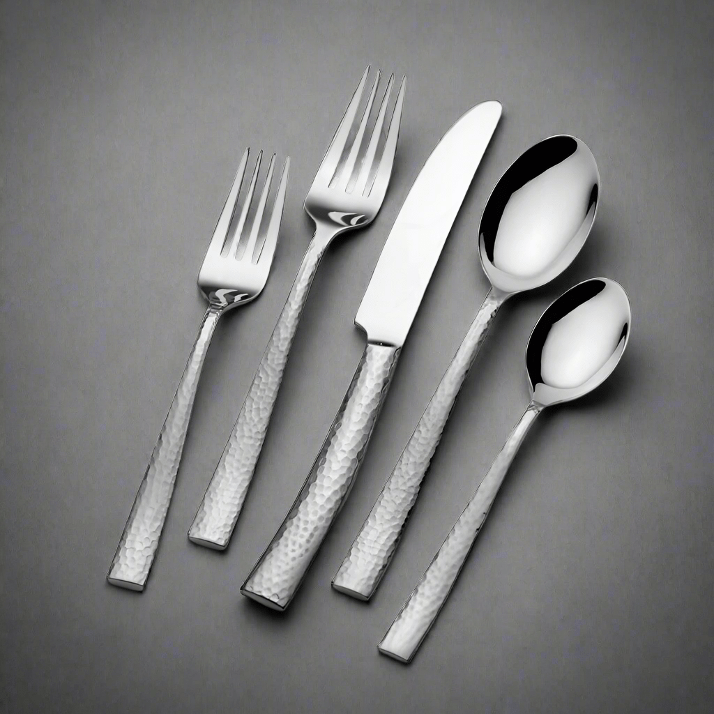 Texture 20 piece flatware set for four with hammered stainless handles arranged on a gray background