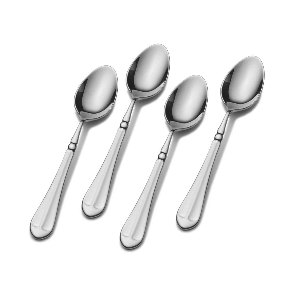 Four polished stainless steel demitasse spoons arranged diagonally with rounded bowls