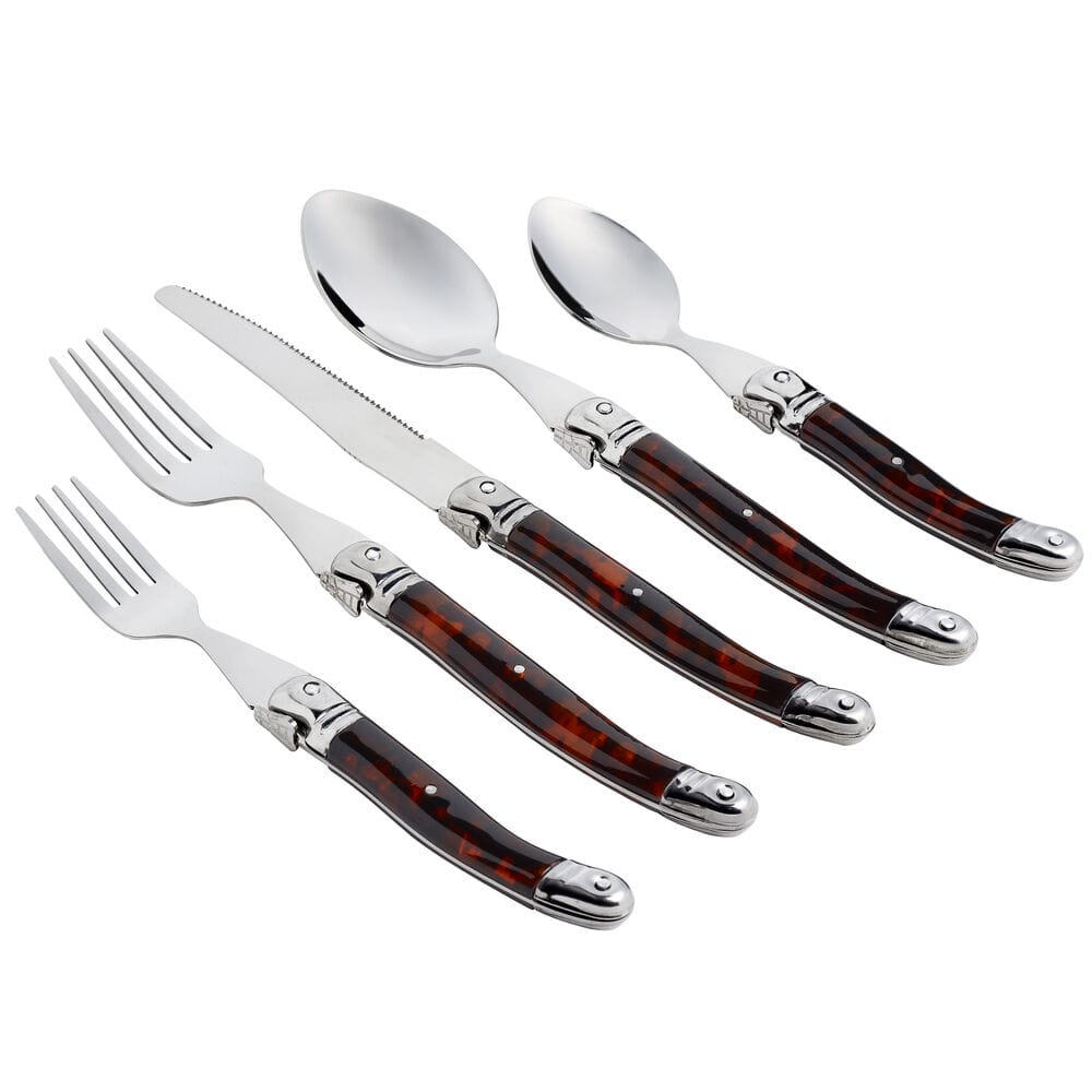 Tortoise shell flatware close up with forks a serrated knife and spoons on a white background
